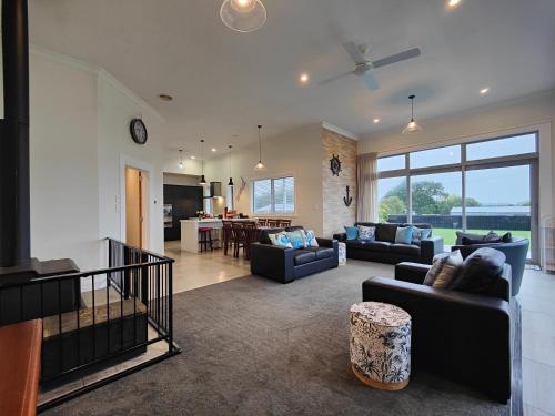 a living room with couches and a dining room at Church Street Charmer in Riverton