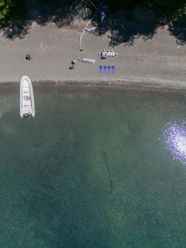 a boat in the water next to a beach at Correntoso Lake & River Hotel in Villa La Angostura