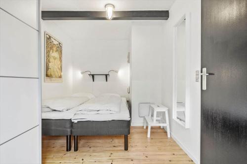 a small bedroom with a bed in a room at 5514-Gudhjem-Holkavej-2-Lejl-3 in Gudhjem