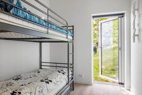 a bedroom with a bunk bed and a window at LF18127-Veslos-Livovej-29 in Vesløs