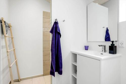 a bathroom with a purple towel hanging on a wall at LF18127-Veslos-Livovej-29 in Vesløs