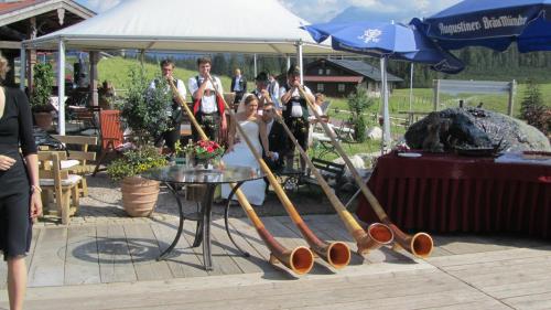 a group of people standing around a table with baseball bats at Winklmoos Sonnenalm in Reit im Winkl