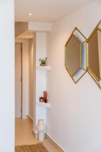 a hallway with white walls and a mirror on the wall at Villa Turquesa Estoril in Alcabideche