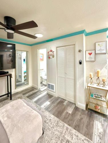 a bedroom with a ceiling fan and a room with a door at Beach Lodge in Santa Cruz