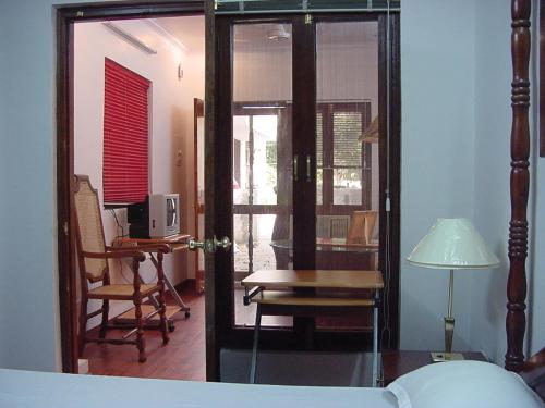 a bedroom with a bed and a desk and a table at Petite Homestays in New Delhi
