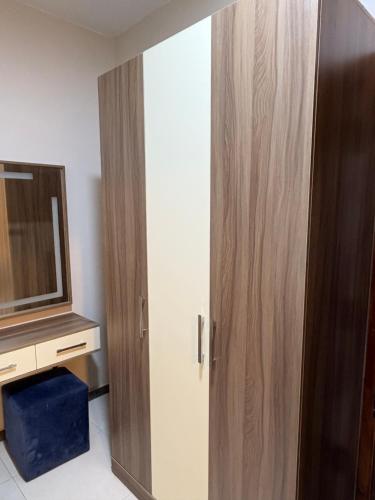 a large wooden cabinet in a room with a tv at Alaska Pyramids Hotel in Cairo