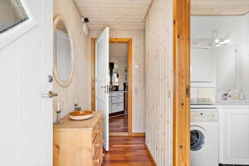 a kitchen with white cabinets and a washer and dryer at FY130-Middelfart-Stjernevej-117 in Middelfart