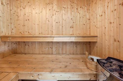 a wooden sauna with a wooden shelf on the wall at FY130-Middelfart-Stjernevej-117 in Middelfart
