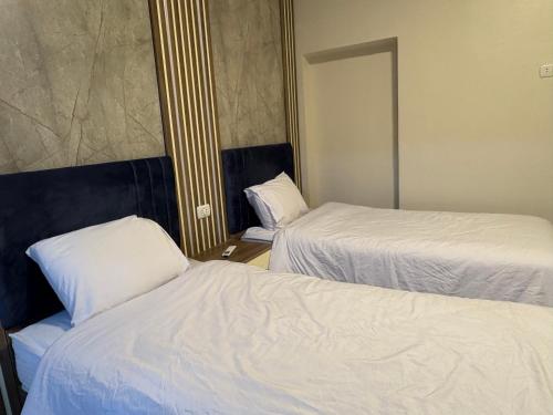a hotel room with two beds and a mirror at Alaska Pyramids Hotel in Cairo