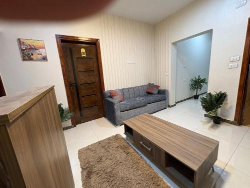 a living room with a couch and a table at Alaska Pyramids Hotel in Cairo
