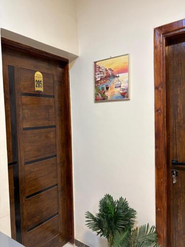 a door in a room with a sign on the wall at Alaska Pyramids Hotel in Cairo