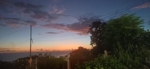a view of a sunset from a street at Gîtes Capra Pomme Surette piscine et spa in Bouillante