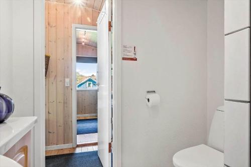 a bathroom with a toilet and a door to a balcony at FY150-Middelfart-Vegavej-24 in Middelfart