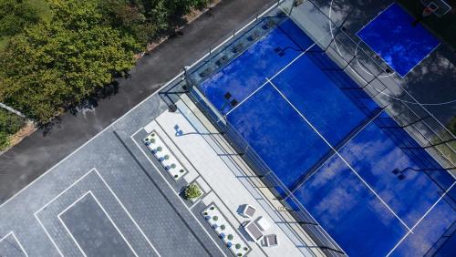 an overhead view of a building with blue windows at Villa Ring Pool & Padel Belgrade in Barič