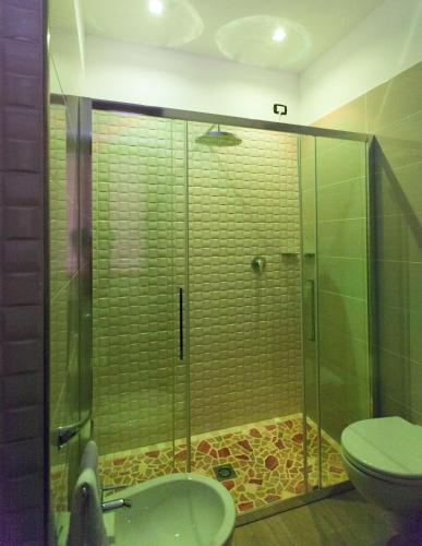 a bathroom with a shower and a toilet at La Suite del Faro in Scalea