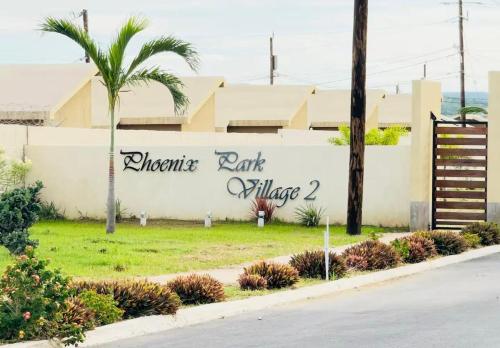 a wall with a sign that reads anchorage park embassy at Phoenix Villa in Portmore