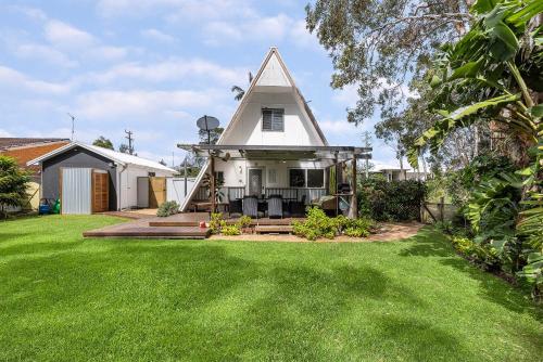 a small white house with a grass yard at Adalene-56 Phillip Drive South West Rocks in South West Rocks