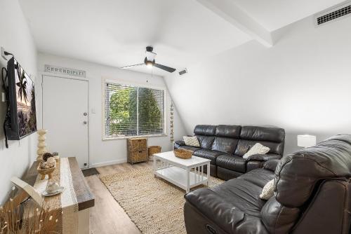 a living room with a leather couch and a table at Adalene-56 Phillip Drive South West Rocks in South West Rocks