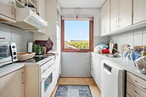 a kitchen with white appliances and a window at FY267-Faaborg-Horsehoved-37 in Fåborg