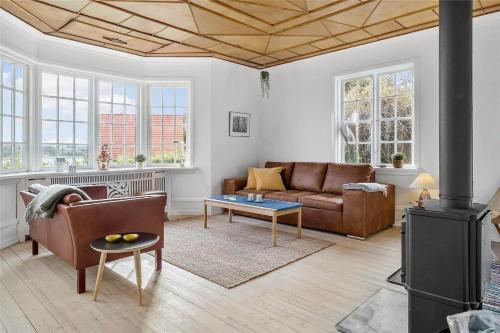a living room with a couch and a table at OH409-Hadsund-Vesterled-2 in Hadsund