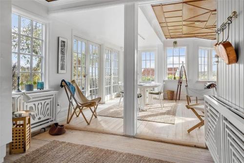 a white living room with a table and chairs at OH409-Hadsund-Vesterled-2 in Hadsund