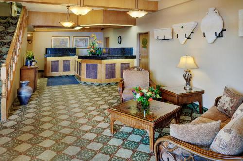 a living room with a couch and a table at Nova Inn Kindersley in Kindersley