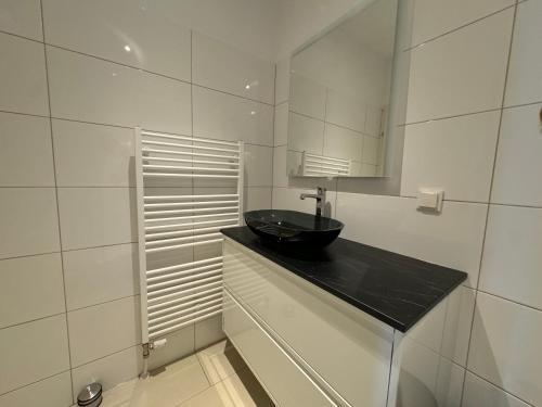 a bathroom with a black sink and a mirror at Cosy Apartment in Classy Area in Vienna