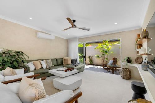 a living room with a couch and a ceiling fan at Belle Escapes Casa Yule in Clifton Beach