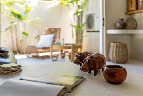a book and a figurine of a dog on a counter at Belle Escapes Casa Yule in Clifton Beach