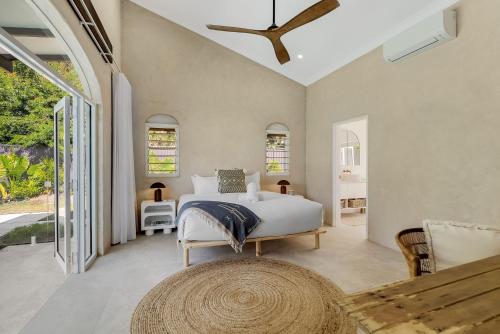 a bedroom with a bed and a large window at Belle Escapes Casa Yule in Clifton Beach