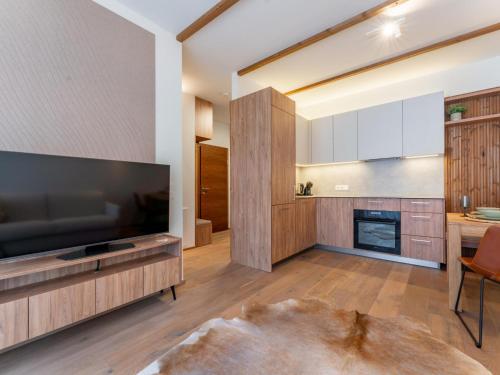 a living room with a large flat screen tv at Sonnenalpe Nassfeld Bergblume in Sonnenalpe Nassfeld