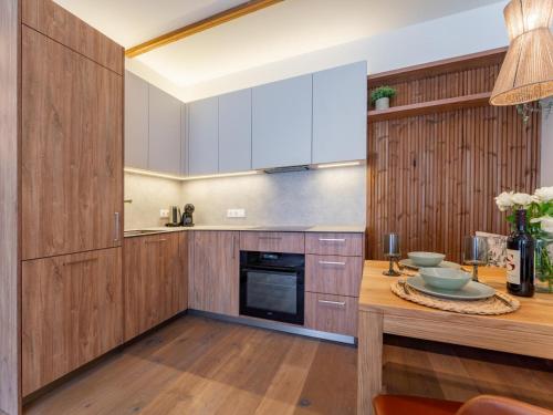 a kitchen with wooden cabinets and a wooden counter top at Sonnenalpe Nassfeld Bergblume in Sonnenalpe Nassfeld