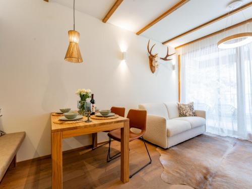 a living room with a table and a couch at Sonnenalpe Nassfeld Bergblume in Sonnenalpe Nassfeld