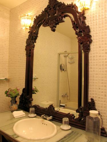 a bathroom with a sink and a large mirror at Dallas Residence in Varna City