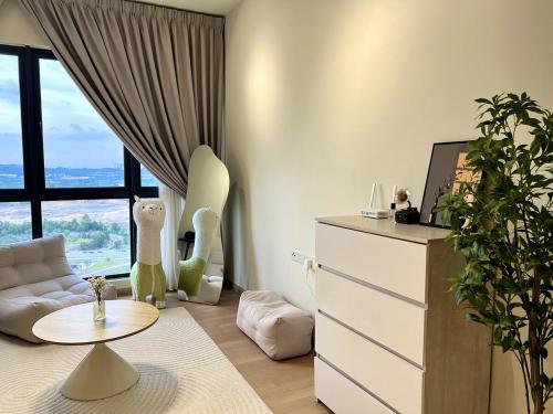 a living room with a couch and a table at Calm MUJI-Inspired Home - Stunning Sunset View - Steps To IOI City Mall - Your Best Urban Retreat in Putrajaya