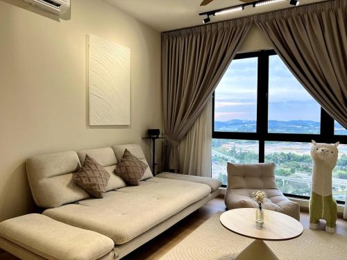 a living room with a couch and a large window at Calm MUJI-Inspired Home - Stunning Sunset View - Steps To IOI City Mall - Your Best Urban Retreat in Putrajaya