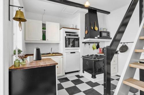 a kitchen with a black and white checkered floor at FY245-Assens-Ramsherred-25 in Assens