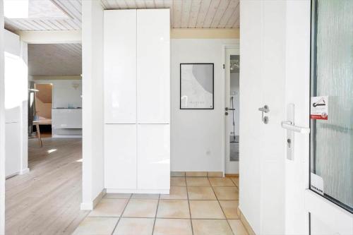 a hallway with white walls and a glass door at FY132-Middelfart-Stjernevej-109 in Middelfart