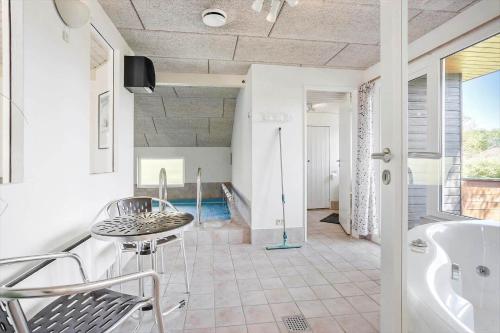 a bathroom with a tub and a table and a sink at FY132-Middelfart-Stjernevej-109 in Middelfart