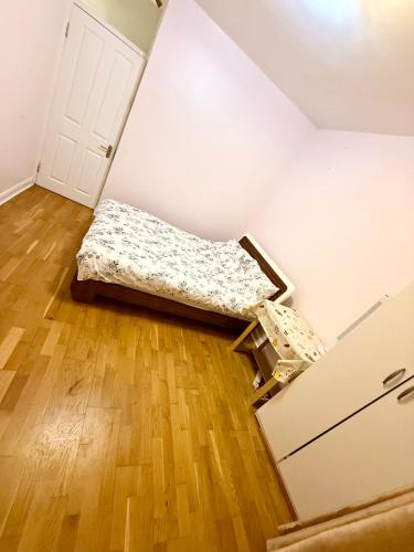 a room with a bed in the corner of a room at Lovely private Room in London