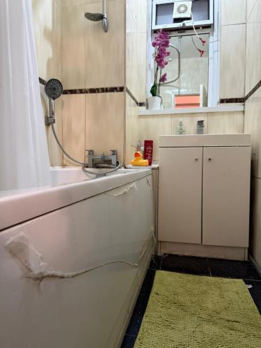 a bathroom with a sink and a mirror at Lovely private Room in London