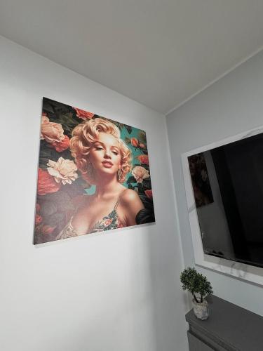 a picture hanging on a wall next to a television at Pool View & Direct Access Margarita Island in Porlamar