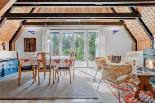 a dining room with a table and chairs at FY174-Asperup-Sommerlandsvej-23 in Asperup