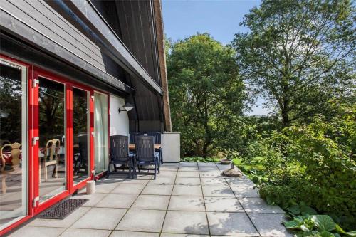 a patio with chairs and tables on a house at FY174-Asperup-Sommerlandsvej-23 in Asperup