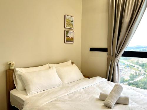 a bedroom with a white bed with a window at Calm MUJI-Inspired Home - Stunning Sunset View - Steps To IOI City Mall - Your Best Urban Retreat in Putrajaya