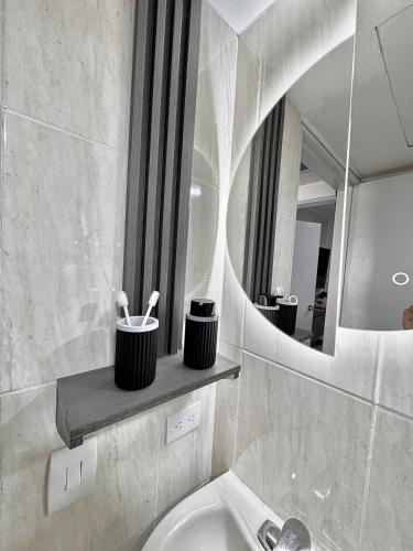 a bathroom with a sink and a mirror at Pool View & Direct Access Margarita Island in Porlamar