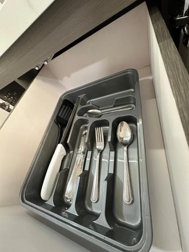 a black tray with utensils in a drawer at Pool View & Direct Access Margarita Island in Porlamar