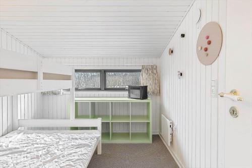 a small bedroom with a bed and a window at FY361-Asperup-Eskelundsvej-18 in Asperup