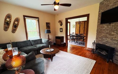 a living room with a couch and a fireplace at The Franklin House in Franklin