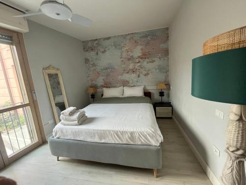 a bedroom with a bed and a painting on the wall at Facibeni Rooms con Parking in Florence